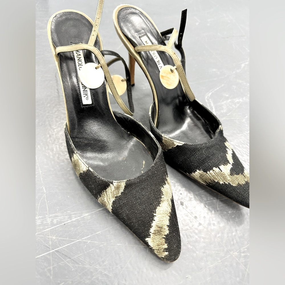 Manolo Blahnik heels with mother of pearl accent on ankle strap.